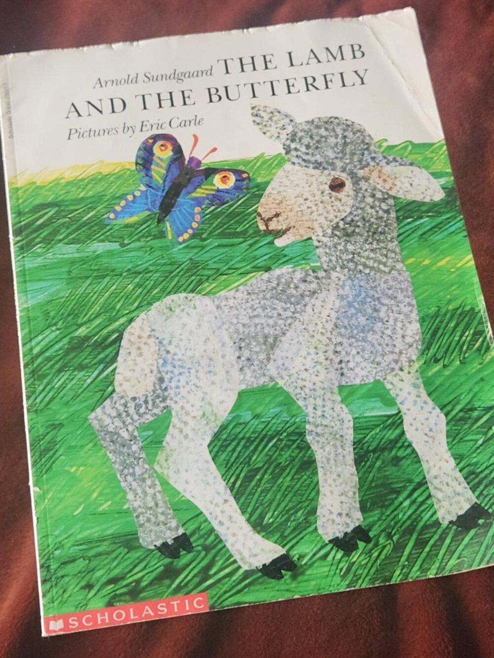 The Lamb and the Butterfly by Arnold Sundgaard. Pictures by Eric Carle.